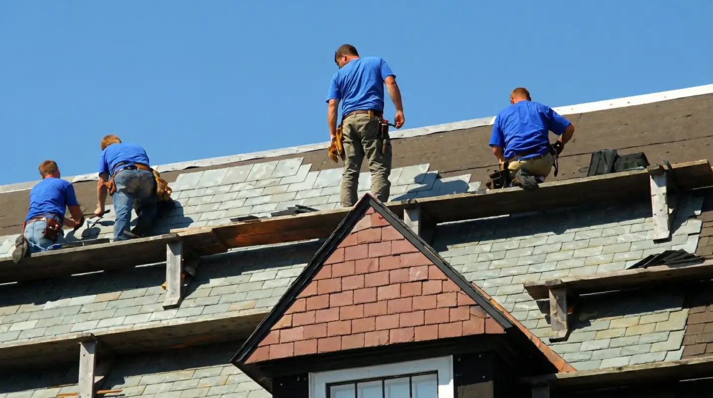Roof replacement in progress with a team of professional contractors installing new shingles on a residential home in Baton Rouge, LA